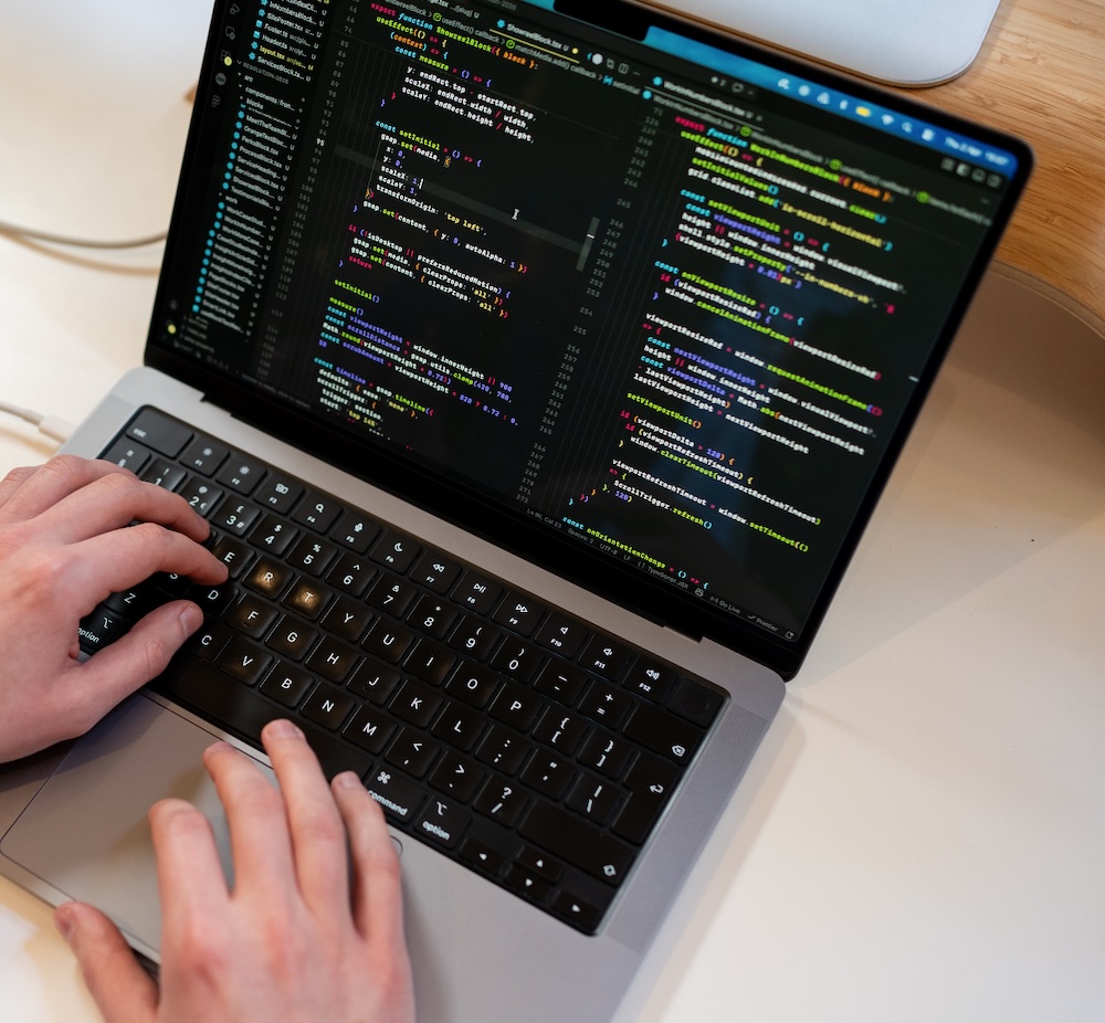 Developer Coding on Macbook Pro