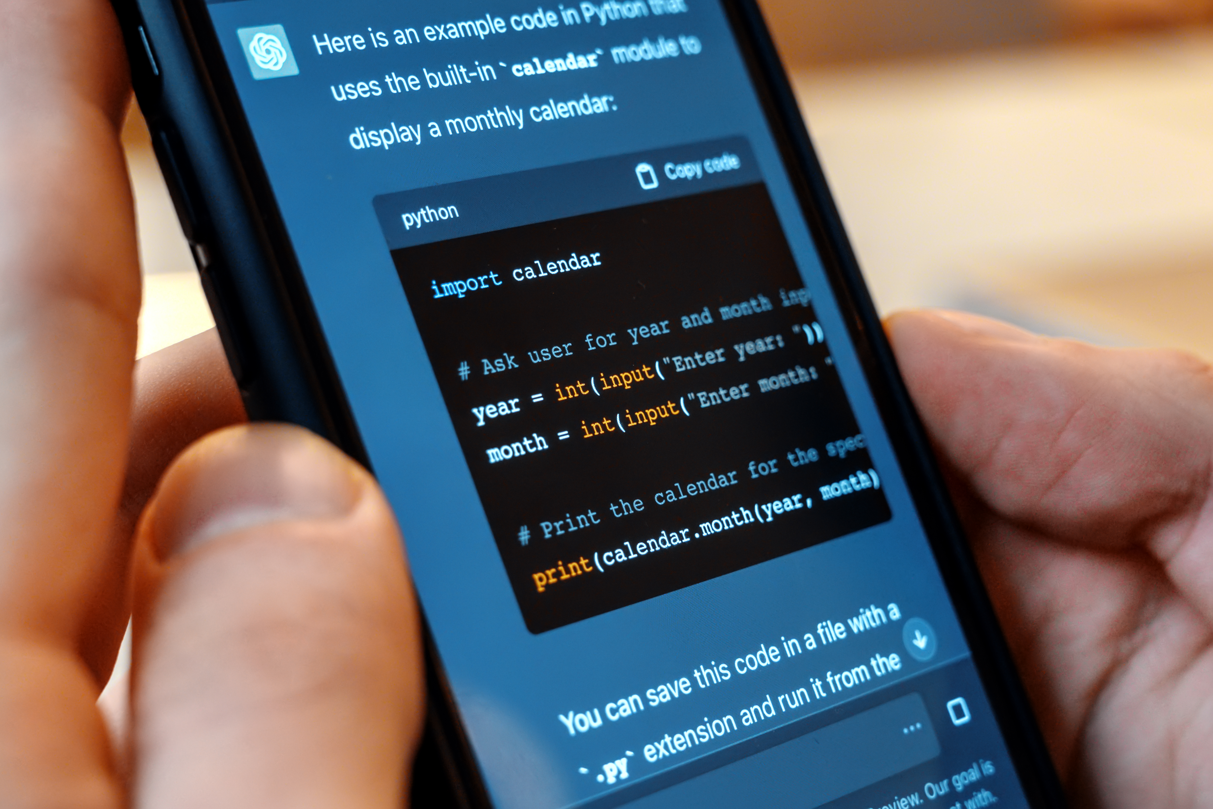 Person holding a mobile phone with website code on it
